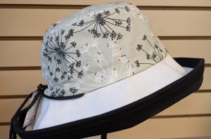 Black brim, soft green with blakc and white flowers