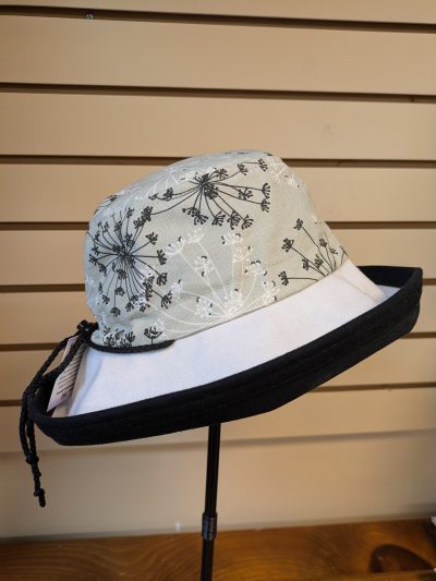 Black brim, soft green with blakc and white flowers