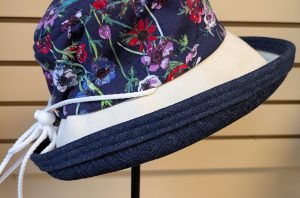 Navy with colorful flowers. dark denim brim